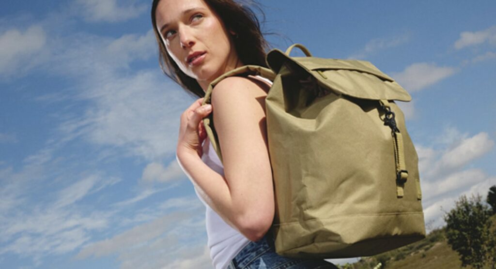 Lefrik at Green Little Heart. A woman with a back pack against a sunny sky.