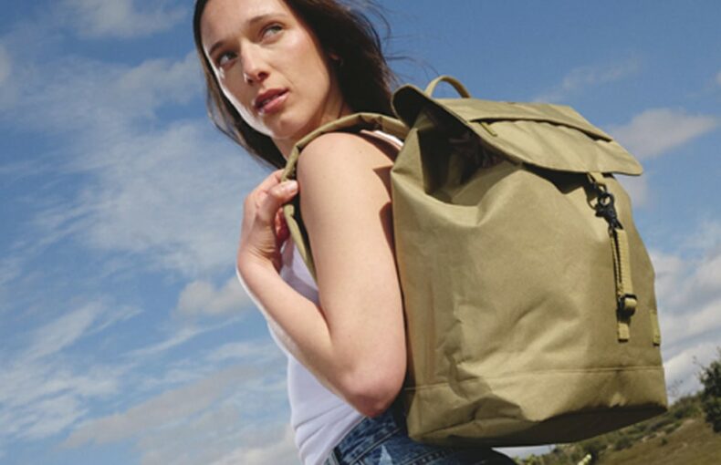 Lefrik at Green Little Heart. A woman with a back pack against a sunny sky.