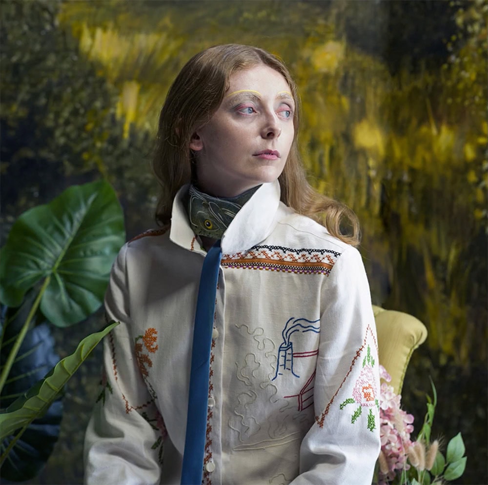 JF Peace design at Green Little Heart, a girl in an arty green forest environment with a remade blouse.